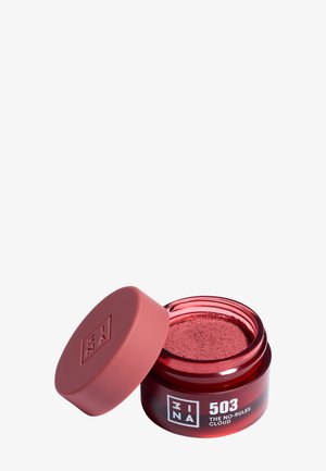 Pot de cosmétique rouge ouvert étiqueté 3INA 503 The No-Rules Cloud avec de la poudre rose à l'intérieur et un couvercle rouge assorti à côté.