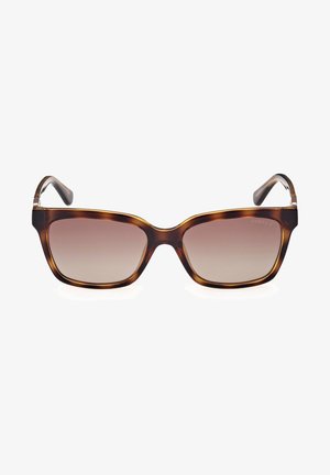 Okulary przeciwsłoneczne w musztardowym kolorze z kwadratową oprawką, gradientowymi soczewkami oraz cienkimi, zakrzywionymi zausznikami. Widok z przodu podkreśla charakterystyczny kształt i kolor.