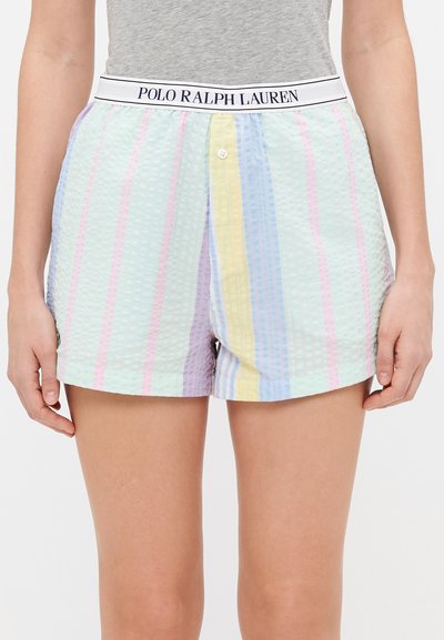 Kort broek met wafeltextuur en pastelkleurige strepen, voorzien van een elastische tailleband met merk en een knoopsluiting aan de voorkant. Kleuren zijn roze, geel en blauw.