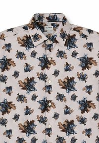 Button-up shirt in light beige fabric featuring a floral pattern in blue, brown, and black. Classic collar with white buttons.