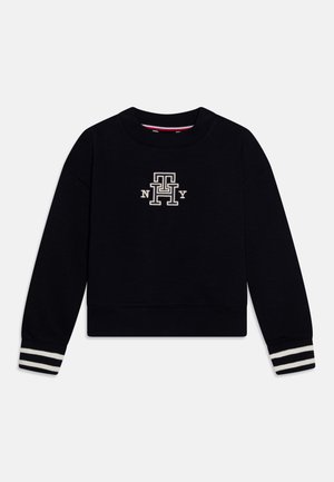 Sort sweatshirt med rund halsudskæring, broderet logo i beige og stribede ærmekanter i creme. Blødt stof, kort design med lange ærmer.