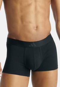 Svarta boxerkalsonger i stretchmaterial, med en bred elastisk midjeband med en diskret logotyp och en figurnära design.