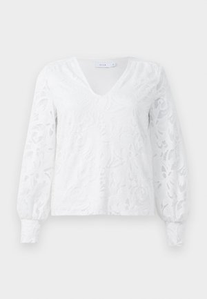 Valge pika varrukaga särk V-kaelusega, millel on tekstuuriga lilleline pitsikujundus ja volditud mansetid. Valmistatud kergest kangast.