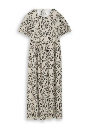 Robe maxi beige clair avec imprimé floral noir, manches courtes bouffantes, taille froncée, encolure ronde et fermeture à nouer dans le dos.