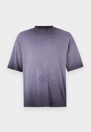 Short-sleeve ribbed knit shirt with faded purple gradient, crew neck, and relaxed fit on a plain light background.