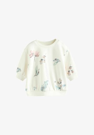 Balts džemperis ar īsām piedurknēm, ar ziedu rakstu maigā rozā un zaļā krāsā. Ribota kakla vieta un elastīga josta.