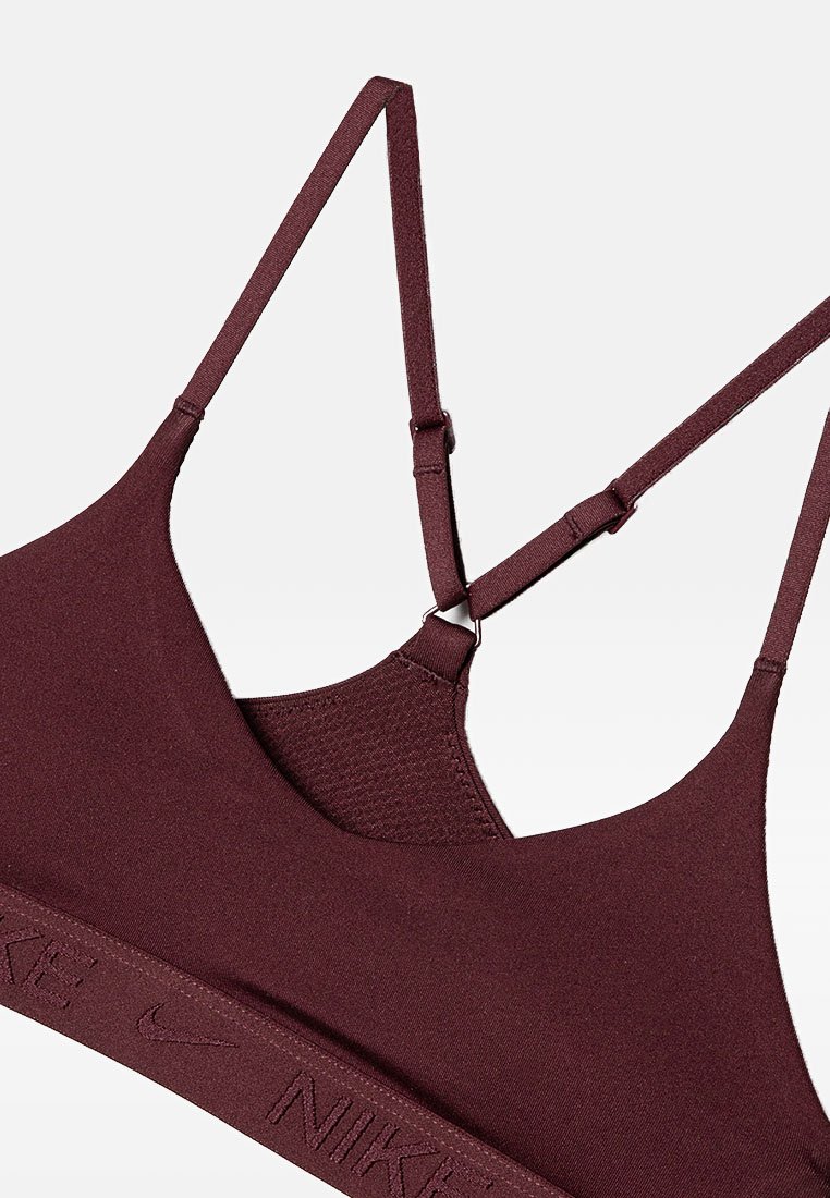 Top sportivo bordeaux con spalline regolabili, pannello in rete sul retro e fascia elastica testurizzata con il logo Nike.