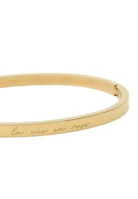 Gold bangle bracelet with a smooth finish and an engraved phrase "la vie en rose." Slim, circular design with a secure clasp.