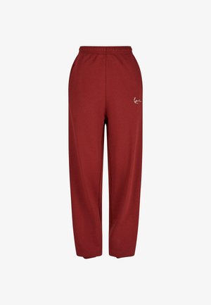 Burgunderfarbene Sweathosen mit lockerer Passform, elastischem Bund und einem weißen Logodetail auf der linken Seite. Hergestellt aus weichem, strukturiertem Stoff.