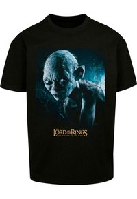 Svart bomull t-skjorte med grafisk trykk av Gollum fra "Ringenes Herre," med blå og grå nyanser i bakgrunnen.