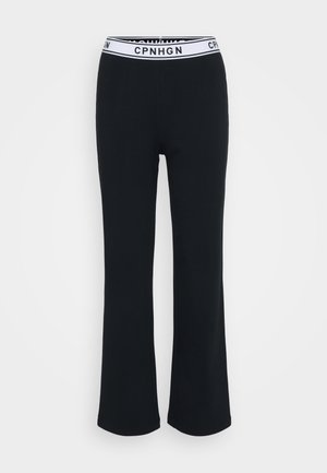 Black flared pants made from a soft fabric, featuring a white elastic waistband with "CPNHGN" branding. Smooth texture, no patterns.