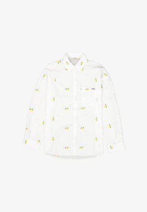 Camisa blanca de manga larga con patrones de frutas en amarillo y verde, que presenta un diseño de botones y un único bolsillo en el pecho con detalle de logo.