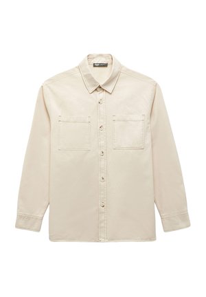 Camicia beige a maniche lunghe con colletto, chiusura frontale con bottoni e due tasche sul petto. Realizzata in un tessuto liscio e leggero.