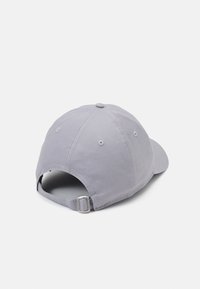 Gray cotton baseball cap with a curved brim, adjustable strap at the back, and ventilation holes on either side.