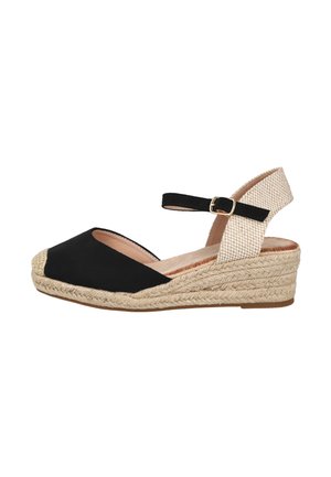 Sandalia cuña espadrille de lona negra con tira trasera beige, hebilla en el tobillo y suela plataforma trenzada de yute.