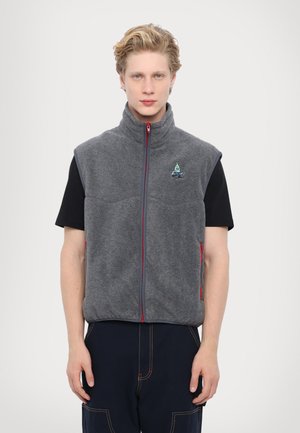 Gray fleece vest with a high collar, red zipper, and side pockets. Features a small logo on the chest and a relaxed fit.