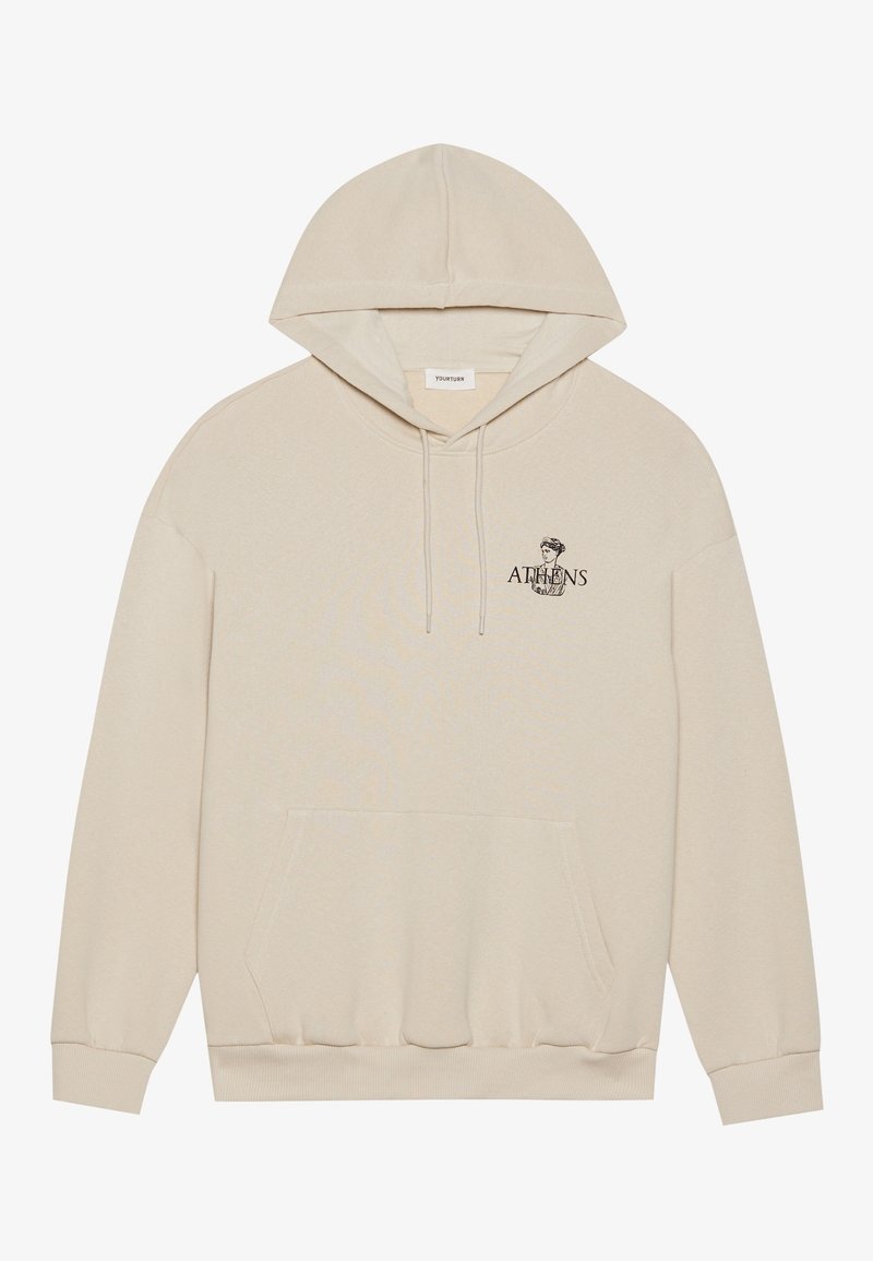 Sweat à capuche beige avec poche frontale et petit texte "ATHENS" ainsi qu'un graphique de buste classique sur le côté gauche de la poitrine.