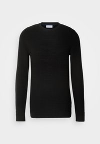 Svart langermet genser med ribbestruktur, rund hals og tettsittende mansjetter. Laget av et mykt, elastisk materiale.