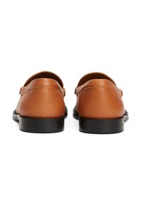 Tan leather loafers featuring a smooth finish, rounded toe, and black rubber sole, designed with a slight heel for added comfort.