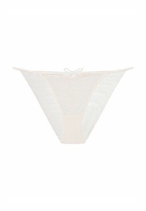 Lace and mesh thong in soft beige, featuring a low-rise design, cut-out sides, and a small bow detail at the center back.