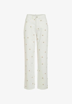 Jean blanc taille haute à jambe droite avec de petits motifs d'étoiles dorées brodées dispersés sur le tissu.