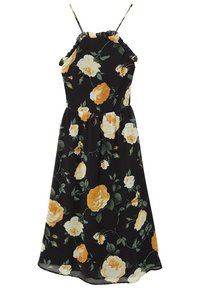 Robe florale en tissu noir avec un décolleté volanté, des fines bretelles et de grandes roses jaunes et blanches avec des feuilles vertes. Silhouette en A.