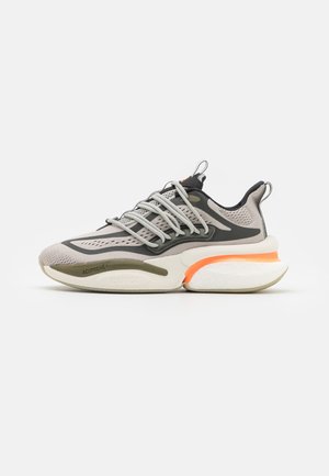 Sport sneakers with a light gray mesh upper, black accents, and orange heel detail. Features a thick white sole with textured grip.