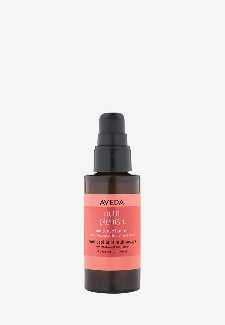 L'huile capillaire multi-usage Aveda Nutri Plenish dans un flacon en verre foncé avec un embout-pompe noir. L'étiquette présente des accents roses et un texte bilingue.