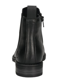 Schwarze Leder-Ankle-Boots von hinten betrachtet, mit einer Zuglasche, seitlichem Reißverschluss und niedrigem, gestapeltem Absatz.