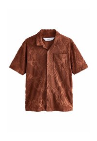 Chemise à manches courtes de couleur rouille, présentant un motif texturé de mains et de soleils, avec une poche poitrine et une fermeture à boutons.