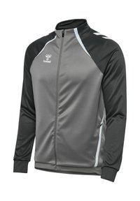 Giacca atletica grigia con spalle nere, chiusura con zip frontale, colletto alto, dettagli bianchi e polsini in maglia; realizzata in un tessuto leggero e liscio.