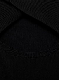 Black ribbed fabric with a textured finish, featuring an overlapping design at the neckline and a circular hemline.