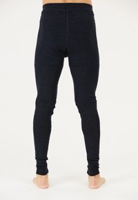 Schwarze figurbetonte Leggings mit glatter Textur, hohem Bund und schmal zulaufenden Beinen, die ein dezentes meliertes Muster zeigen und keine sichtbaren Beschläge aufweisen.