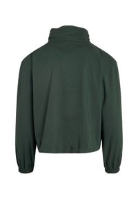 Dunkelgrüne Jacke mit langen Ärmeln, elastischen Bündchen und hohem Kragen, von hinten auf weißem Hintergrund gezeigt.