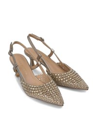 Beige slingback heels featuring a pointed toe, covered in small, shiny studs. Thin ankle strap and a low, block heel provide support.