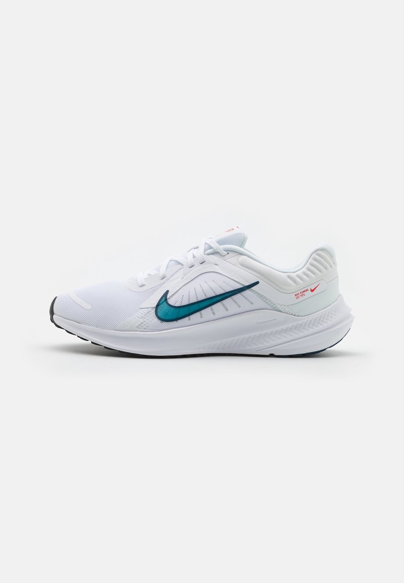 White athletic shoe with a mesh upper, teal swoosh logo, and textured accents. Features a cushioned sole and black rubber outsole.