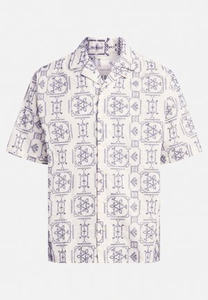 Short-sleeved shirt in cream and navy, featuring an all-over pattern of floral and geometric designs, with a notched collar and front buttons.