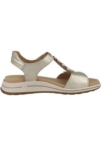 Metallic gold sandals with a T-strap design, faux leather material, cushioned insole, and rubber sole. Features chain accent on strap.