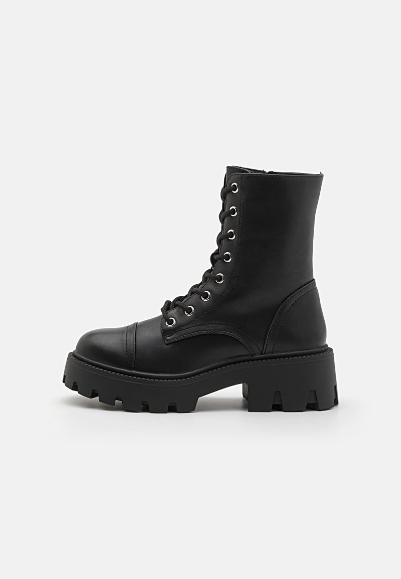 Black leather ankle boots with a chunky sole, lace-up front, reinforced toe, and smooth texture. Features metal eyelets for laces.