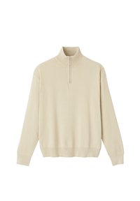 Pull beige à col haut et fermeture éclair mi-zip. Texture tricotée, manches longues et ourlet et poignets côtelés pour un look ajusté.