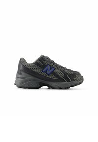 Black athletic shoe featuring a mesh upper, textured rubber sole, and a prominent blue "N" logo on the side. Curved design enhances flexibility.