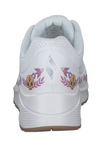 Weiße Sportschuhe mit einer strukturierten Oberseite, bunten Schädel- und Vogelgrafiken, Blattakzenten und einer gepolsterten Sohle.