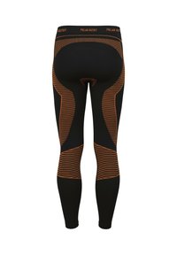 Black thermal leggings featuring orange geometric and striped patterns. Elastic waistband with "POLAR HUSKY" branding. Form-fitting design.