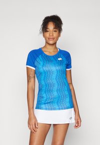 Blue athletic shirt with a textured pattern, white accents, and a round neckline. Paired with a white skirt, showcasing a sporty design.