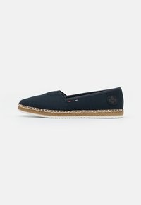 Navy canvas espadrille with a rounded toe, a woven jute sole, and white stitching. Features a black logo patch on the side.