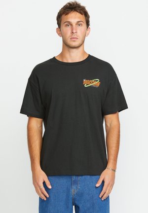 Camiseta de algodón negra con cuello redondo y mangas cortas, que presenta un gráfico colorido de "VOLCOM" en el lado izquierdo del pecho.