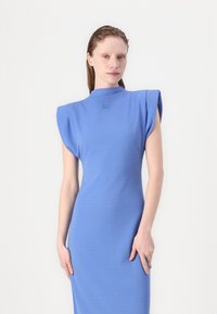 Form-fitting, sleeveless dress in solid light blue fabric, featuring a high neckline and structured shoulder design. Subtle logo detail at chest.