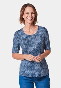 T-shirt à motif marine avec des manches courtes et un col rond. Tissu en mélange de coton avec un imprimé géométrique et une coupe décontractée.