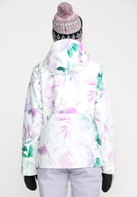 Waterdichte jas met bloemenpatroon in het wit met pastelroze en groene accenten. Zacht materiaal, verstelbare capuchon en zwarte gebreide muts.