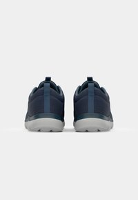 Blue athletic shoes with a textured upper, rounded silhouette, and light gray rubber sole. Features a pull tab at the heel for easy wear.